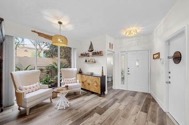 This is an elegantly renovated residence tucked within one of on PGA National Golf Club in Florida - for sale on GolfHomes.com, golf home, golf lot