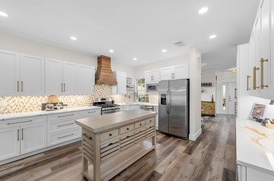 This is an elegantly renovated residence tucked within one of on PGA National Golf Club in Florida - for sale on GolfHomes.com, golf home, golf lot