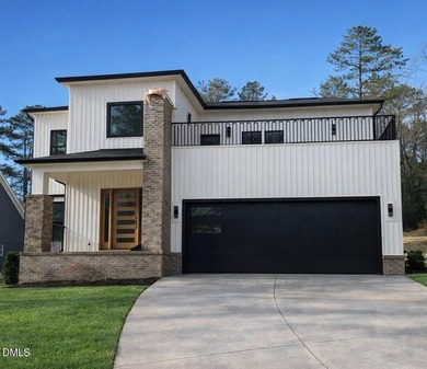 Stunning modern new construction in the gated lake community of on River Golf and Country Club at Lake Royale in North Carolina - for sale on GolfHomes.com, golf home, golf lot