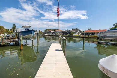WELCOME TO PARADISE SAYS THIS WATERFRONT BEAUTY IN THE GATED & on Isla Del Sol Yacht and Country Club in Florida - for sale on GolfHomes.com, golf home, golf lot