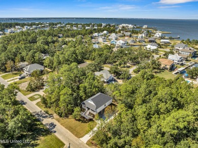 This beautiful new construction is a quick golf cart ride to all on Pass Christian Isles Golf Club in Mississippi - for sale on GolfHomes.com, golf home, golf lot