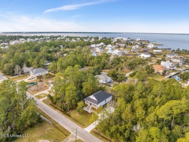 This beautiful new construction is a quick golf cart ride to all on Pass Christian Isles Golf Club in Mississippi - for sale on GolfHomes.com, golf home, golf lot