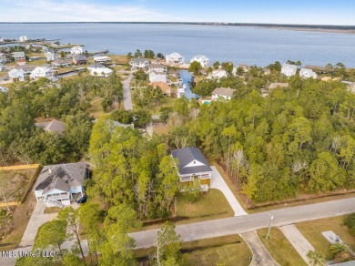 This beautiful new construction is a quick golf cart ride to all on Pass Christian Isles Golf Club in Mississippi - for sale on GolfHomes.com, golf home, golf lot