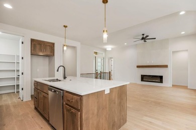 The Woodland by Elevate Design + Build is a reverse 1.5-story 5 on Heritage Park Golf Course in Kansas - for sale on GolfHomes.com, golf home, golf lot