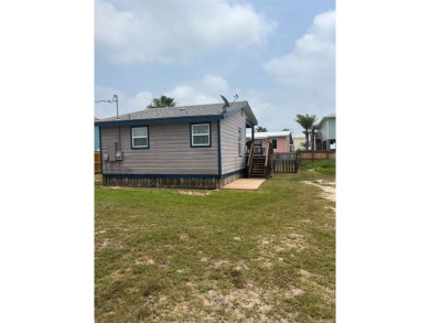 This adorable cozy coastal cottage sits on a large lot just 2 on Rockport Country Club in Texas - for sale on GolfHomes.com, golf home, golf lot