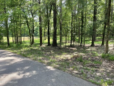Beautiful, wooded lot with pond.  Perfect for your dream home on Annandale Golf Club in Mississippi - for sale on GolfHomes.com, golf home, golf lot