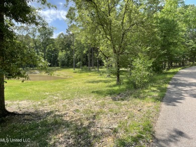Beautiful, wooded lot with pond.  Perfect for your dream home on Annandale Golf Club in Mississippi - for sale on GolfHomes.com, golf home, golf lot