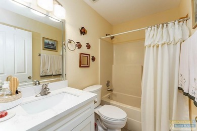 Inviting lakefront home with golf course views, set along a on South Padre Island Golf Club in Texas - for sale on GolfHomes.com, golf home, golf lot