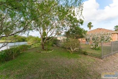 Inviting lakefront home with golf course views, set along a on South Padre Island Golf Club in Texas - for sale on GolfHomes.com, golf home, golf lot