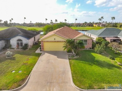 Inviting lakefront home with golf course views, set along a on South Padre Island Golf Club in Texas - for sale on GolfHomes.com, golf home, golf lot