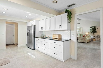 Discover the ultimate blend of elegance and effortless living in on Quail Ridge Golf Course and Country Club in Florida - for sale on GolfHomes.com, golf home, golf lot