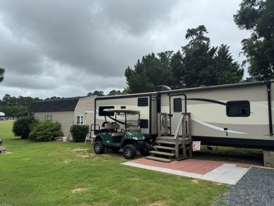 Lot with lots of extras.  Camper included is in great condition on Captains Cove Golf and Yacht Club in Virginia - for sale on GolfHomes.com, golf home, golf lot