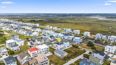 Luxurious Island Living in Sunset Beach: A Stunning 6-Bedroom, 6 on Oyster Bay Golf Links in North Carolina - for sale on GolfHomes.com, golf home, golf lot