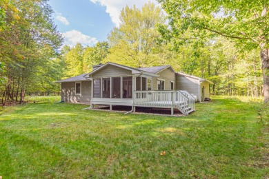 Nestled in a quiet and secluded area of Canadian Lakes, this on Canadian Lakes Country Club-The Royal Course in Michigan - for sale on GolfHomes.com, golf home, golf lot