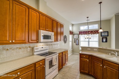 Golf-front living, sunset views, and coastal convenience-this on Meadowlands Golf Club in North Carolina - for sale on GolfHomes.com, golf home, golf lot