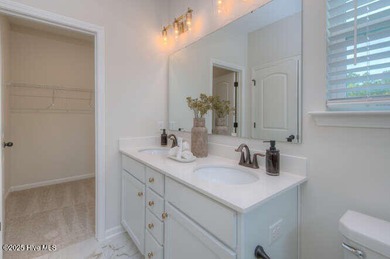 Welcome to this beautifully appointed 4-bedroom, 3-bath home on Carolina National Golf Club in North Carolina - for sale on GolfHomes.com, golf home, golf lot