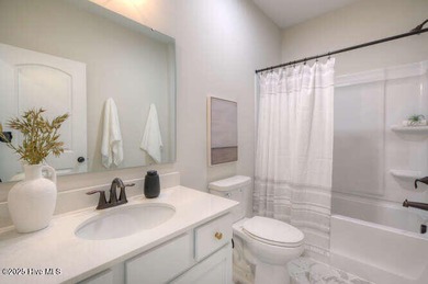 Welcome to this beautifully appointed 4-bedroom, 3-bath home on Carolina National Golf Club in North Carolina - for sale on GolfHomes.com, golf home, golf lot