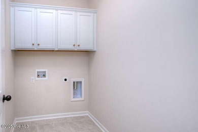 Welcome to this beautifully appointed 4-bedroom, 3-bath home on Carolina National Golf Club in North Carolina - for sale on GolfHomes.com, golf home, golf lot