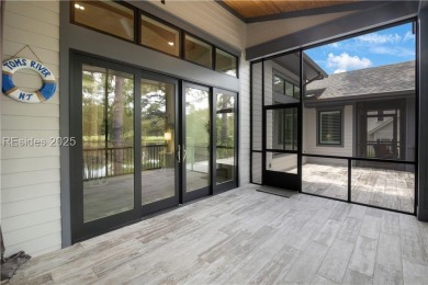 Enjoying views across a lake toward Moss Creek South's 8th Hole on Moss Creek Golf Club in South Carolina - for sale on GolfHomes.com, golf home, golf lot