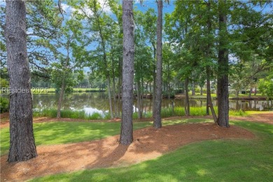Enjoying views across a lake toward Moss Creek South's 8th Hole on Moss Creek Golf Club in South Carolina - for sale on GolfHomes.com, golf home, golf lot