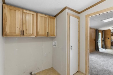 Welcome to this beautifully updated 4-bedroom, 2-bath ranch home on Indian River Golf Club in Michigan - for sale on GolfHomes.com, golf home, golf lot