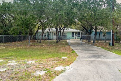 Nestled beneath large shade oak trees, this fully furnished on Rockport Country Club in Texas - for sale on GolfHomes.com, golf home, golf lot