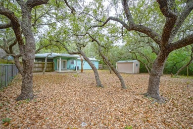 Nestled beneath large shade oak trees, this fully furnished on Rockport Country Club in Texas - for sale on GolfHomes.com, golf home, golf lot