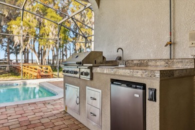 Set along approximately 82 feet of shimmering Lake Dora on Deer Island Country Club in Florida - for sale on GolfHomes.com, golf home, golf lot