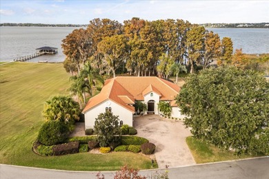 Set along approximately 82 feet of shimmering Lake Dora on Deer Island Country Club in Florida - for sale on GolfHomes.com, golf home, golf lot