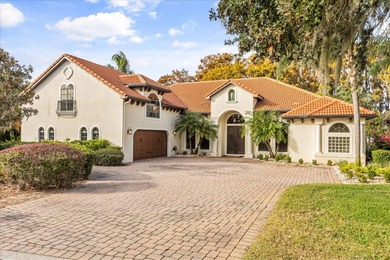 Set along approximately 82 feet of shimmering Lake Dora on Deer Island Country Club in Florida - for sale on GolfHomes.com, golf home, golf lot
