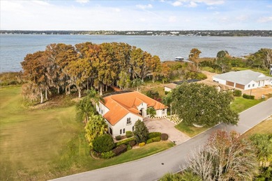 Set along approximately 82 feet of shimmering Lake Dora on Deer Island Country Club in Florida - for sale on GolfHomes.com, golf home, golf lot