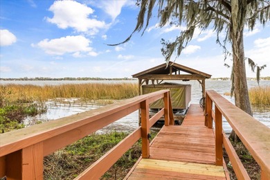 Set along approximately 82 feet of shimmering Lake Dora on Deer Island Country Club in Florida - for sale on GolfHomes.com, golf home, golf lot