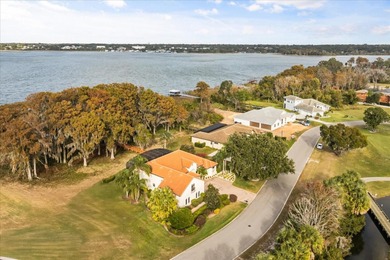 Set along approximately 82 feet of shimmering Lake Dora on Deer Island Country Club in Florida - for sale on GolfHomes.com, golf home, golf lot