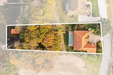 Set along approximately 82 feet of shimmering Lake Dora on Deer Island Country Club in Florida - for sale on GolfHomes.com, golf home, golf lot