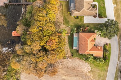 Set along approximately 82 feet of shimmering Lake Dora on Deer Island Country Club in Florida - for sale on GolfHomes.com, golf home, golf lot