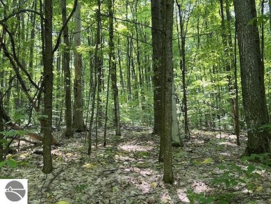 Towering hardwoods in a quiet cul-de-sac location and a large on Cedar River Golf Course in Michigan - for sale on GolfHomes.com, golf home, golf lot