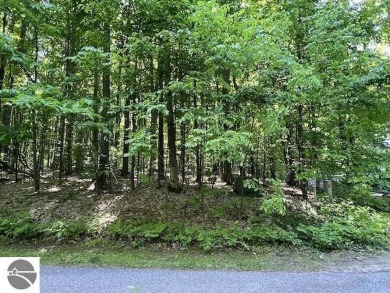 Towering hardwoods in a quiet cul-de-sac location and a large on Cedar River Golf Course in Michigan - for sale on GolfHomes.com, golf home, golf lot