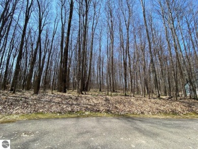 Towering hardwoods in a quiet cul-de-sac location and a large on Cedar River Golf Course in Michigan - for sale on GolfHomes.com, golf home, golf lot
