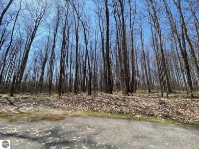 Towering hardwoods in a quiet cul-de-sac location and a large on Cedar River Golf Course in Michigan - for sale on GolfHomes.com, golf home, golf lot