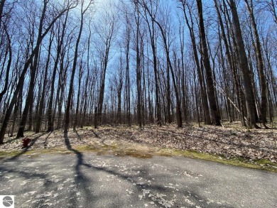 Towering hardwoods in a quiet cul-de-sac location and a large on Cedar River Golf Course in Michigan - for sale on GolfHomes.com, golf home, golf lot