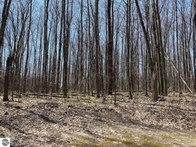Towering hardwoods in a quiet cul-de-sac location and a large on Cedar River Golf Course in Michigan - for sale on GolfHomes.com, golf home, golf lot