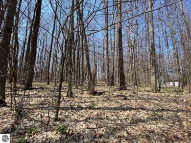 Towering hardwoods in a quiet cul-de-sac location and a large on Cedar River Golf Course in Michigan - for sale on GolfHomes.com, golf home, golf lot