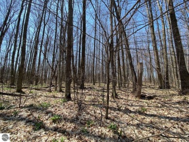 Towering hardwoods in a quiet cul-de-sac location and a large on Cedar River Golf Course in Michigan - for sale on GolfHomes.com, golf home, golf lot