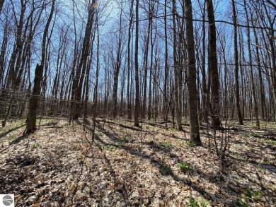 Towering hardwoods in a quiet cul-de-sac location and a large on Cedar River Golf Course in Michigan - for sale on GolfHomes.com, golf home, golf lot