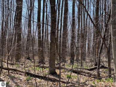 Towering hardwoods in a quiet cul-de-sac location and a large on Cedar River Golf Course in Michigan - for sale on GolfHomes.com, golf home, golf lot