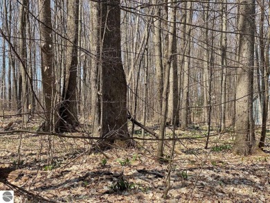 Towering hardwoods in a quiet cul-de-sac location and a large on Cedar River Golf Course in Michigan - for sale on GolfHomes.com, golf home, golf lot