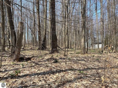 Towering hardwoods in a quiet cul-de-sac location and a large on Cedar River Golf Course in Michigan - for sale on GolfHomes.com, golf home, golf lot