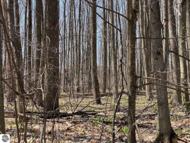Towering hardwoods in a quiet cul-de-sac location and a large on Cedar River Golf Course in Michigan - for sale on GolfHomes.com, golf home, golf lot