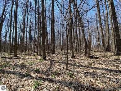 Towering hardwoods in a quiet cul-de-sac location and a large on Cedar River Golf Course in Michigan - for sale on GolfHomes.com, golf home, golf lot
