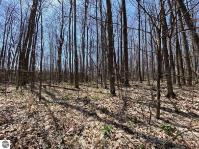 Towering hardwoods in a quiet cul-de-sac location and a large on Cedar River Golf Course in Michigan - for sale on GolfHomes.com, golf home, golf lot